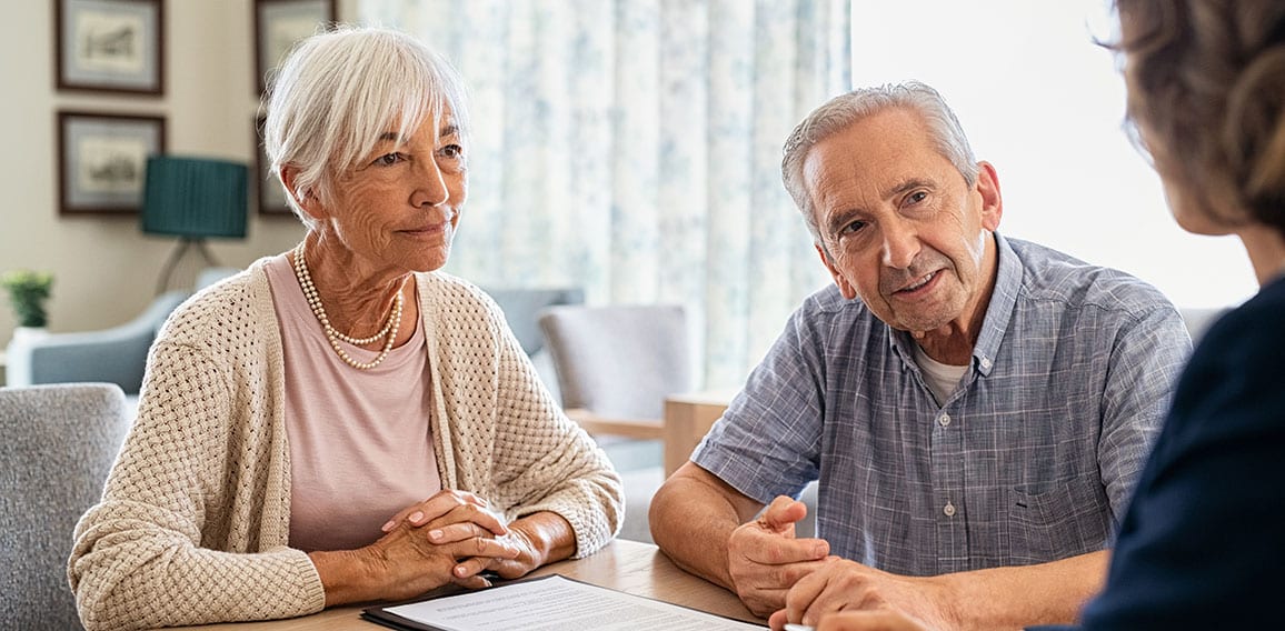 Senior couple planning their investments with financial advisor