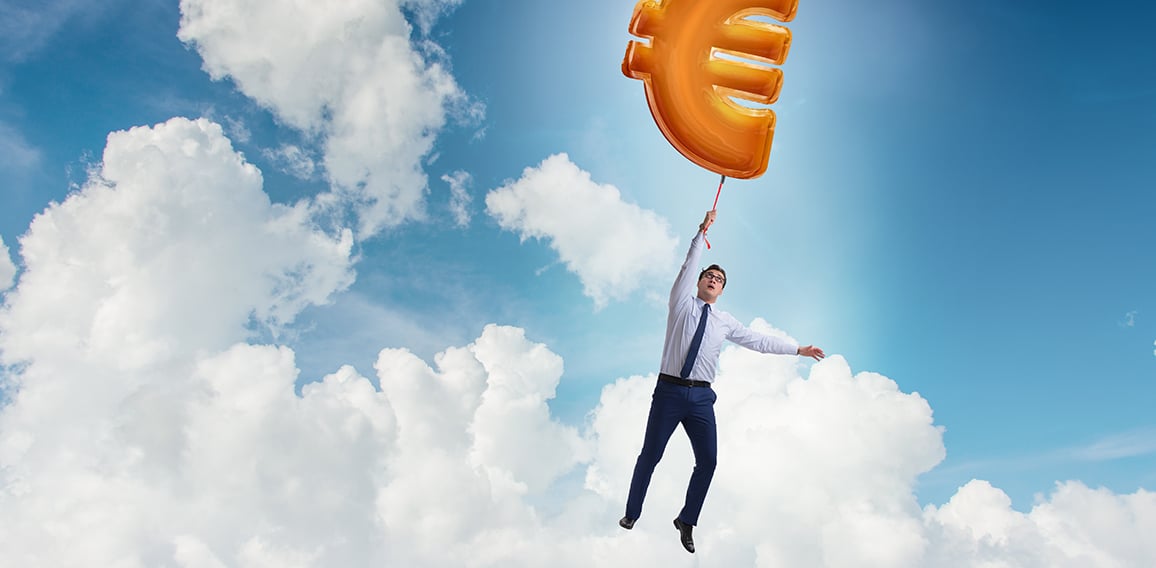 Businessman flying on euro sign inflatable balloon