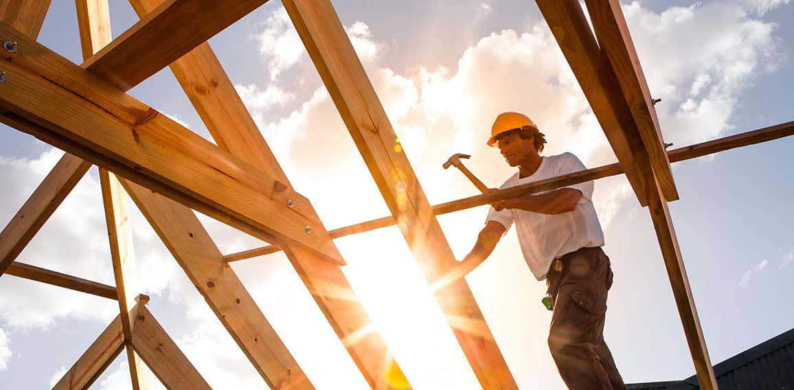 roofer ,carpenter working on roof structure at construction site