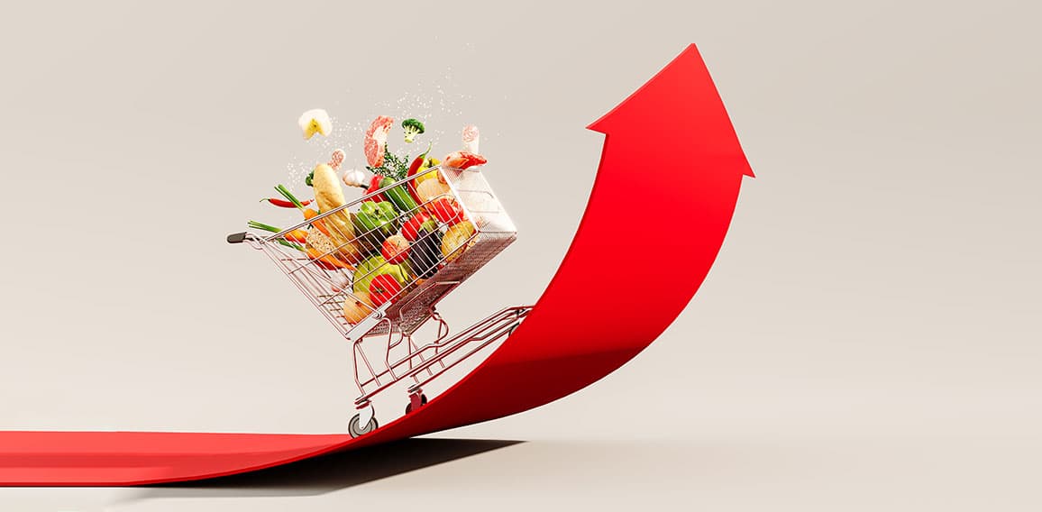 Food cost rising concept. Shopping cart full of groceries and re