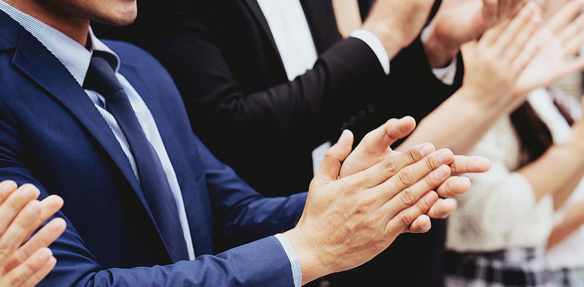 Group of businessmen are clapping their hands to congratulate th