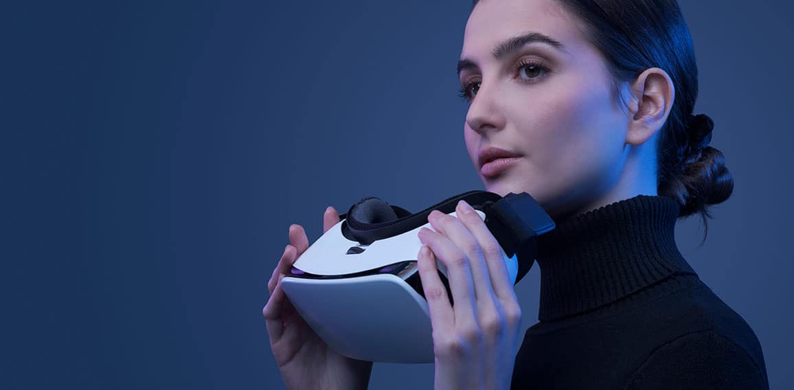 Beautiful woman holding a VR headset