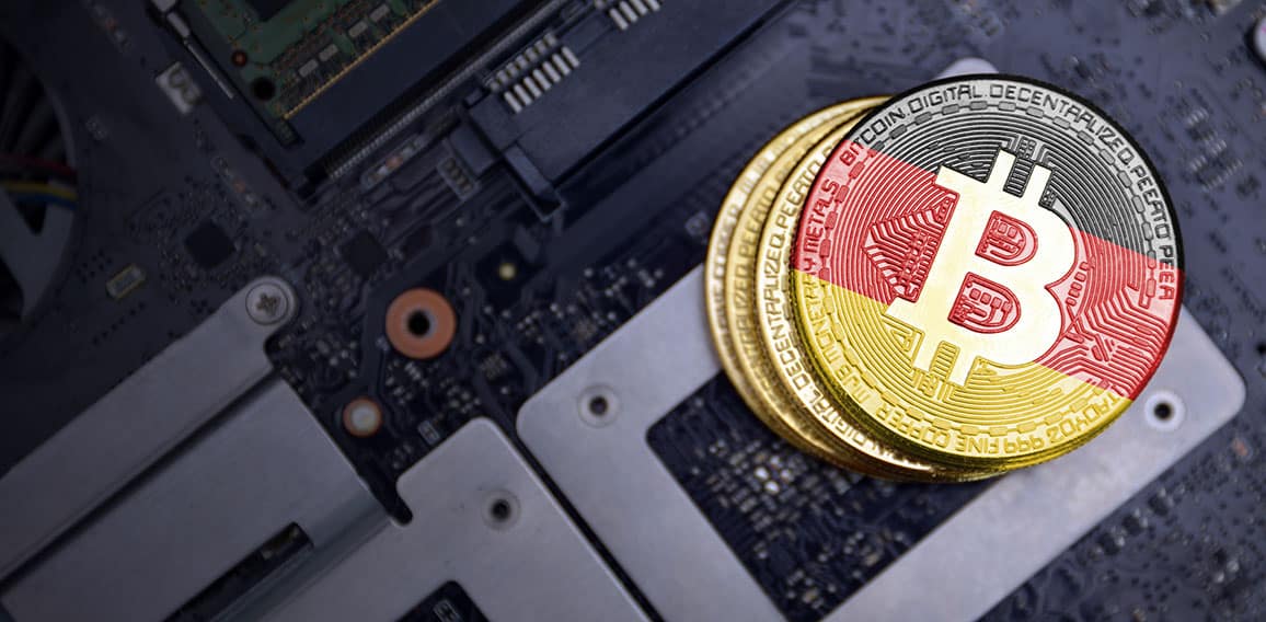 golden bitcoins with flag of germany on a computer electronic circuit board. bitcoin mining concept.