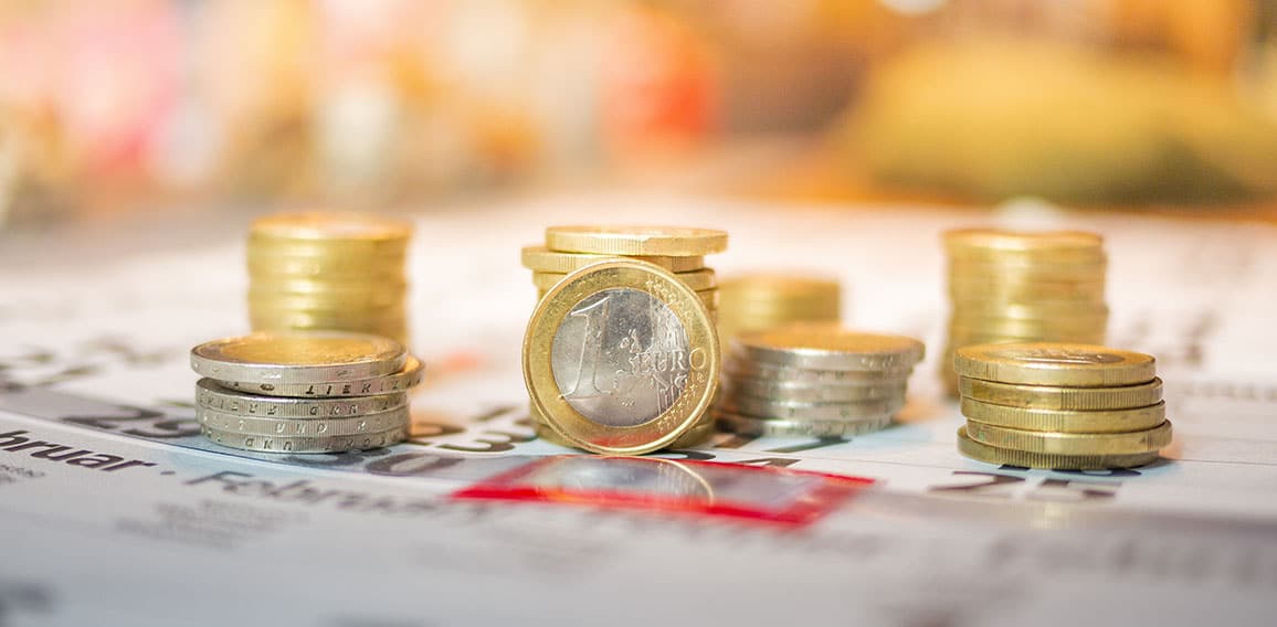 Image of Euro coin stacks on calender indicating pay day