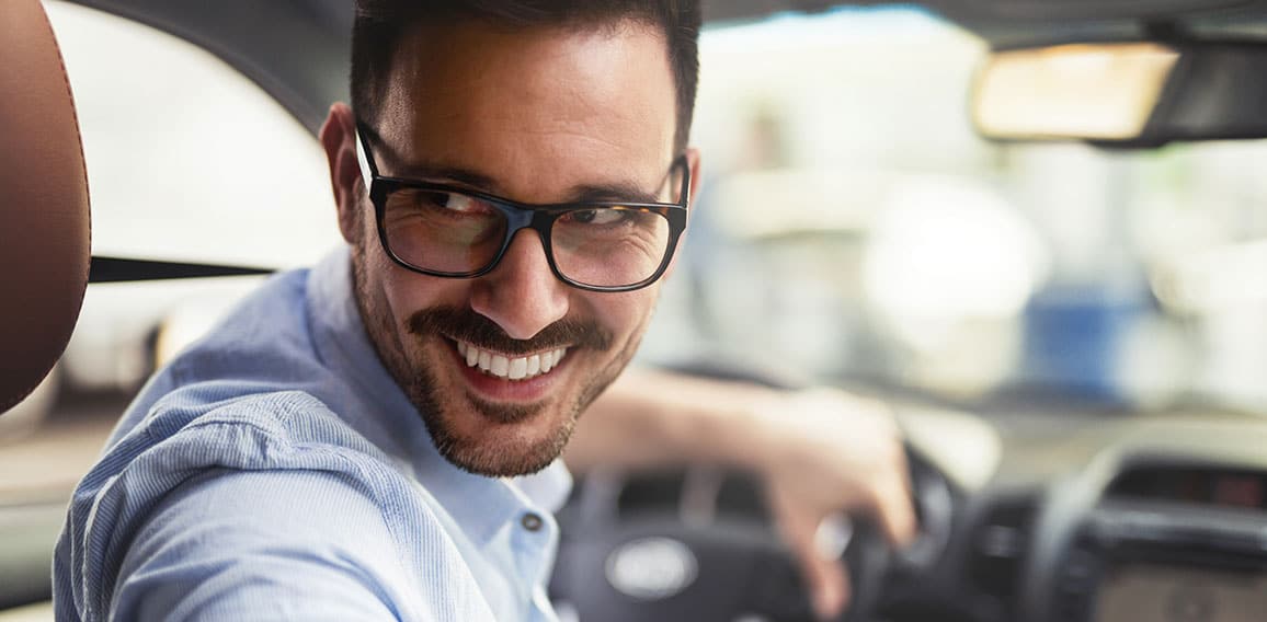 Handsome businessman driving a car to work