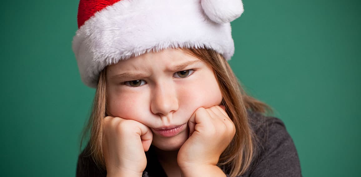 Grumpy Christmas Girl in Santa Hat, Isolated on Green