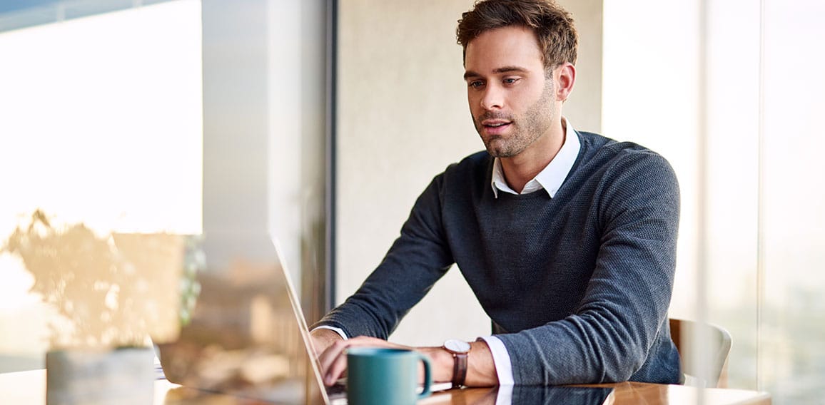 Young businessman working on a laptop at home