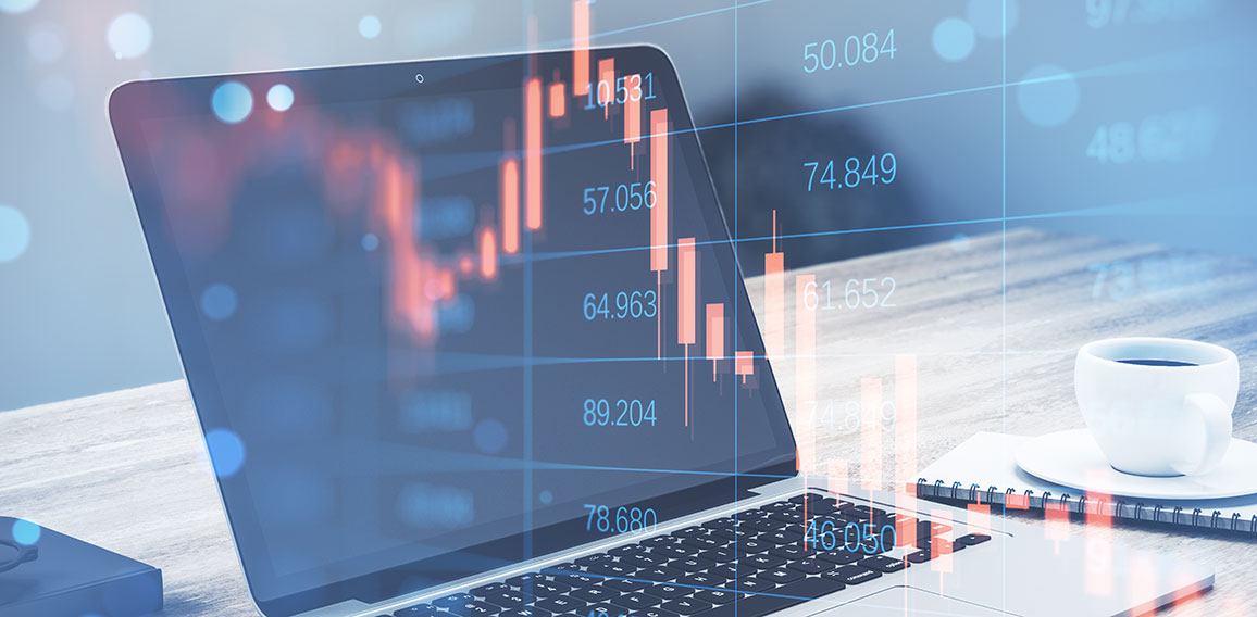 Close up of laptop with abstract falling candlestick forex chart on blurry background. Crisis, workplace and stock concept. Double exposure.