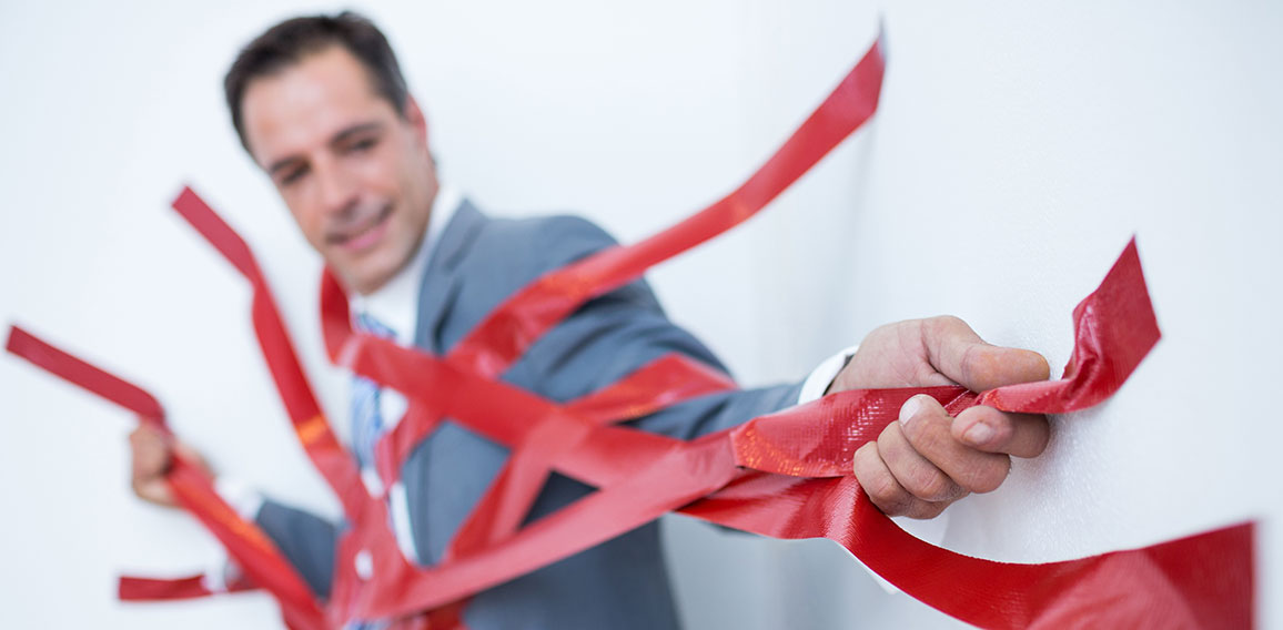 Businessman trapped by red tape