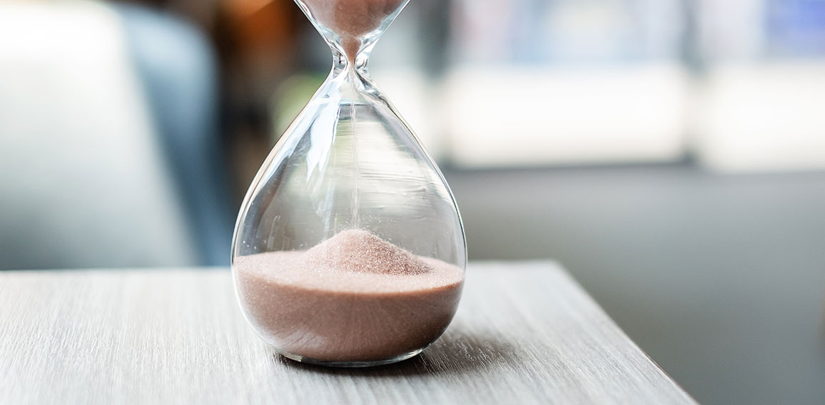 Hourglass on table office with copy space, Sand flowing through