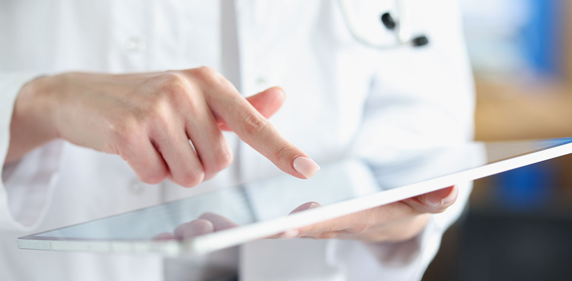 Medical officer doctor points his finger at tablet