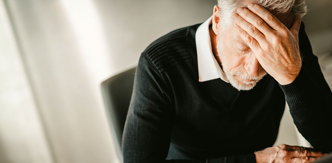 Stressed businessman sitting in office