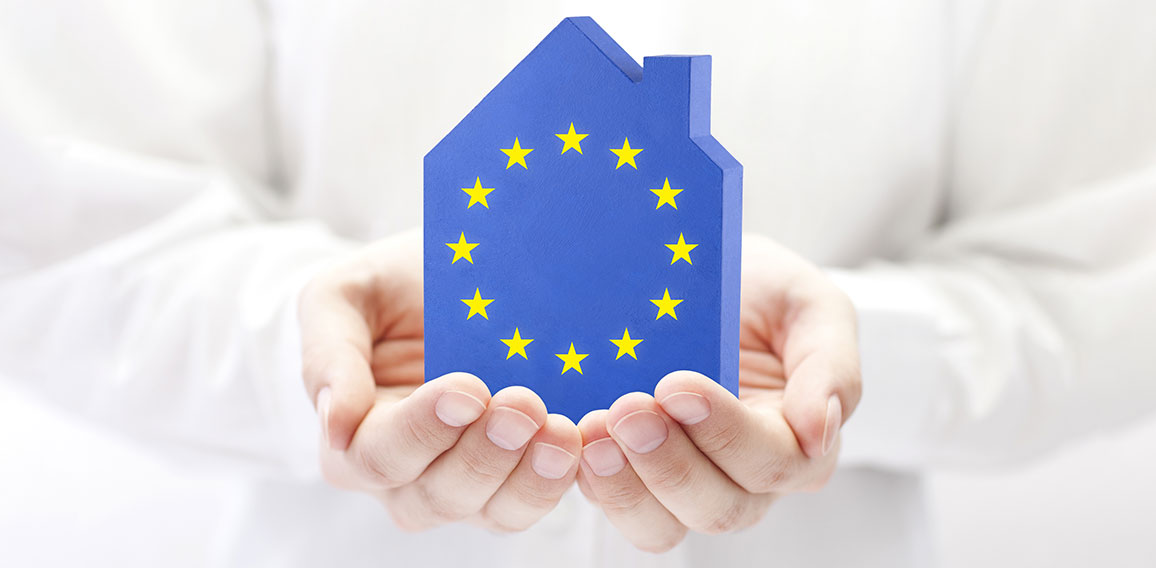 House with European Union flag in hands