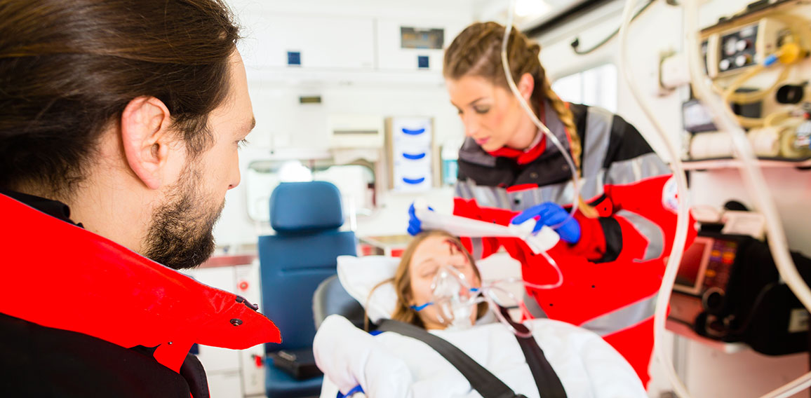 Ambulance helping injured woman with infusion