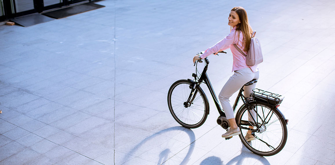 Young woman with modern city electric e-bike clean sustainable u