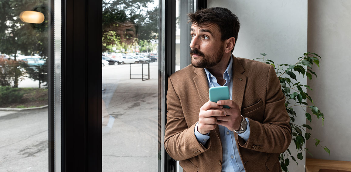 Young business man waiting for the taxi or cab that he called or