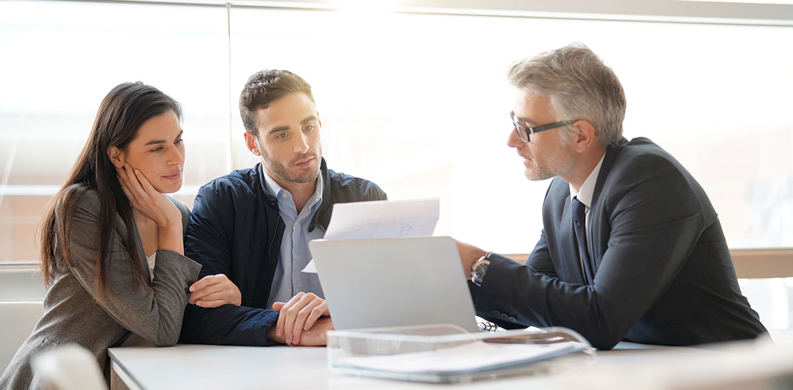 Young couple meeting financial advisor for home investment