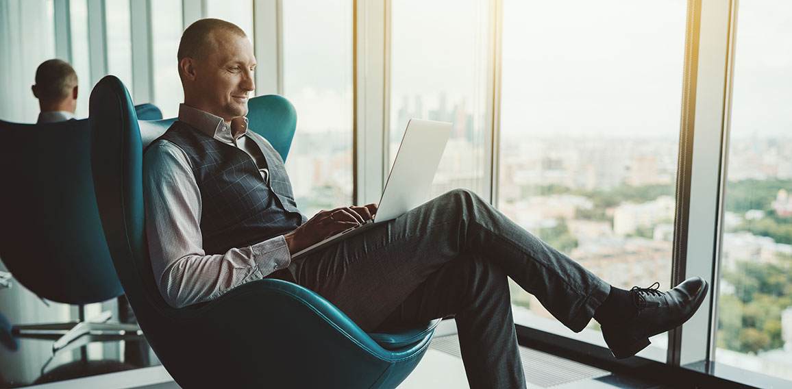 A businessman is using a laptop