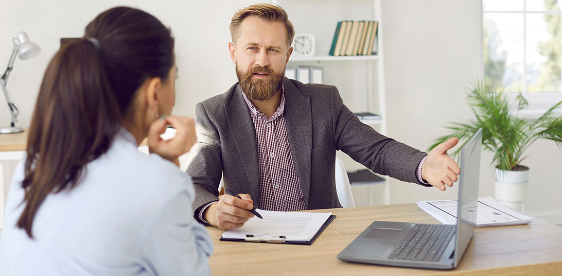 Male manager provides advice to female client and acquaints her with terms of contract.