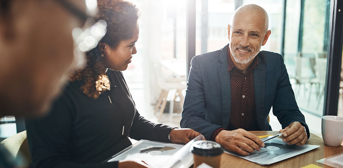 Business meeting, team and planning in office for strategy discussion, vision or success. Happy corporate group, woman and businessman for collaboration at financial agency for goal, target or budget