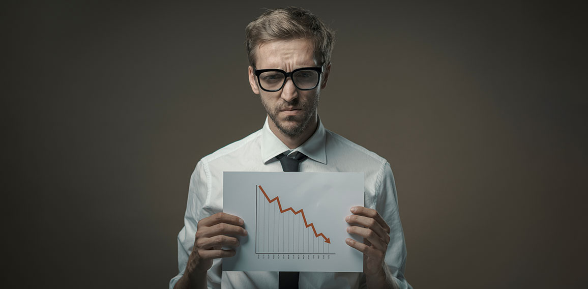 Businessman holding a negative financial chart