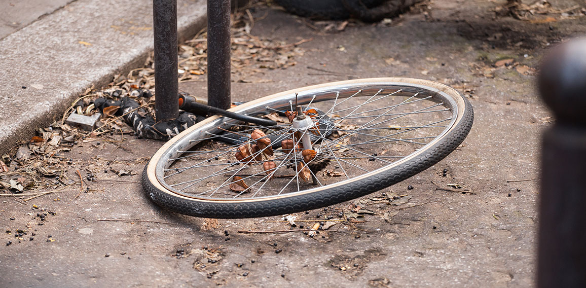 Locked bicycle wheel at bike parking