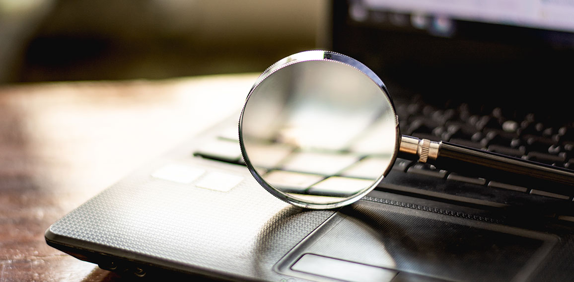 Magnifying glass is located on the keyboard. Of computer noteboo