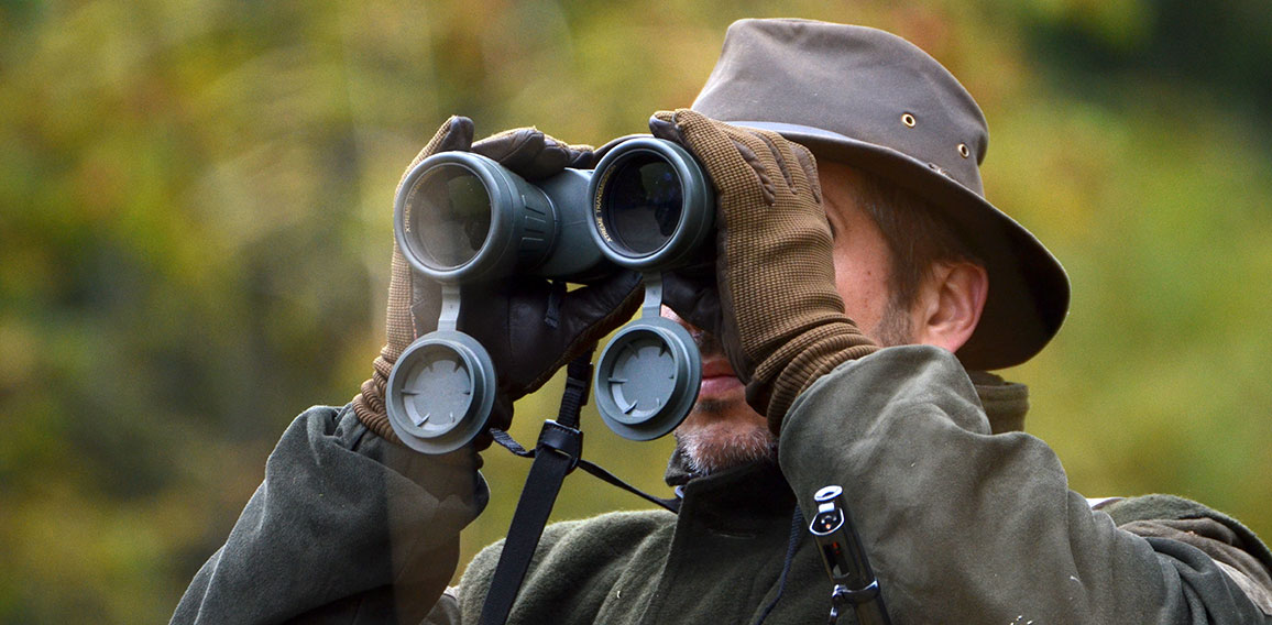 hunter looking through binoculars