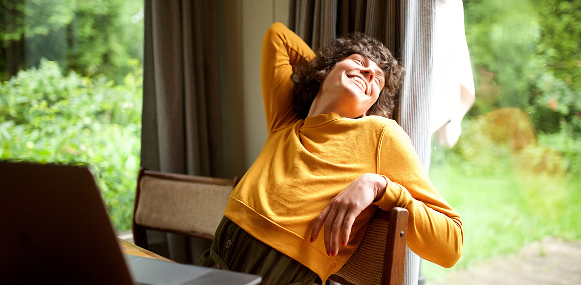 woman relaxing at home looking out of window