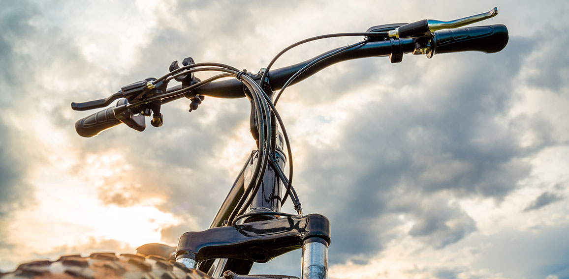 A Bicycle with thick wheels against a beautiful sky.