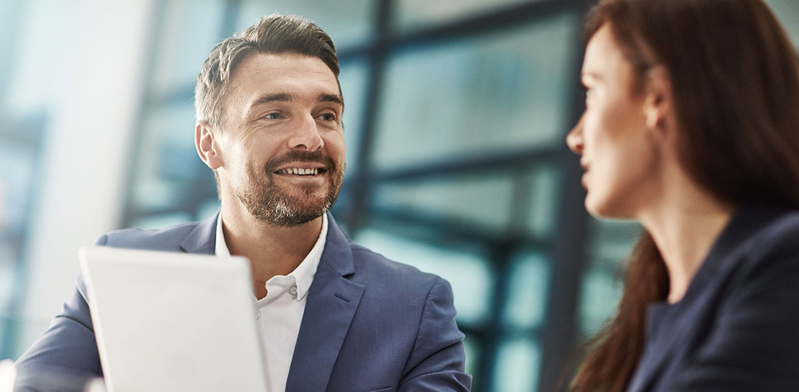 Tablet, teamwork and business people meeting in office workplace. Collaboration, technology and man, woman or employees with touchscreen planning sales strategy or researching finance plan in company