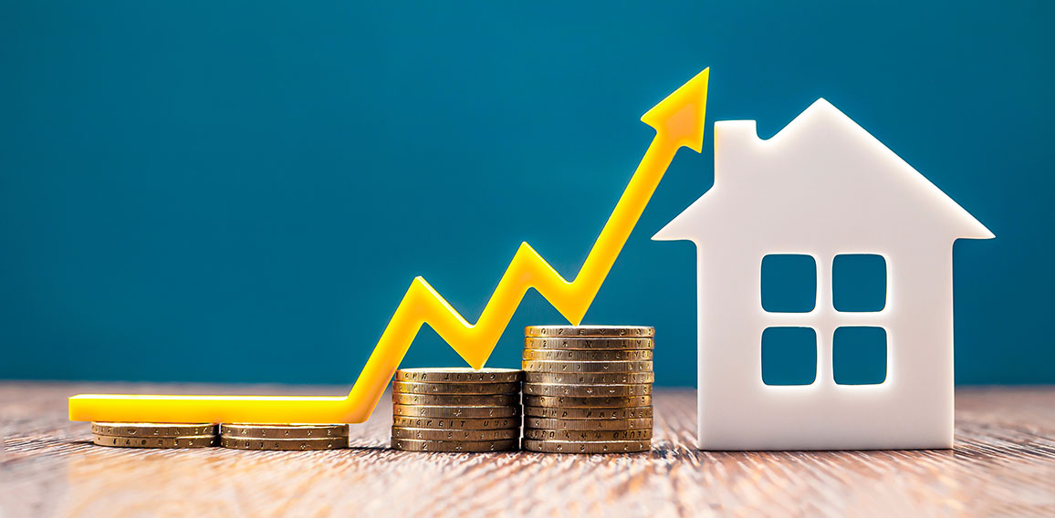 Real estate market, graph, up arrow. House model and a stack of coins. The concept of inflation, economic growth, the price of insurance services