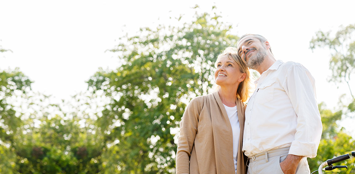 Senior Caucasian couple hugging in park. Family with a happy smi