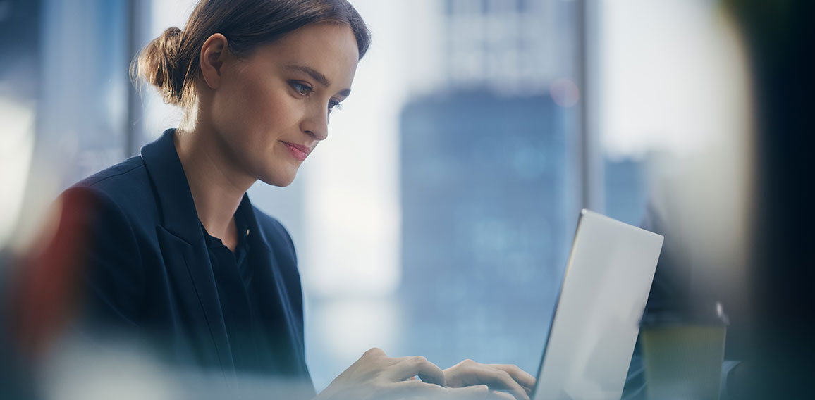 Close Up Portrait of a Successful Businesswoman Working on Lapto