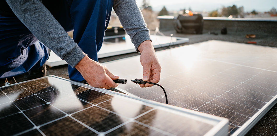 Worker installing solar energy panels. Alternative energy system. eco concept