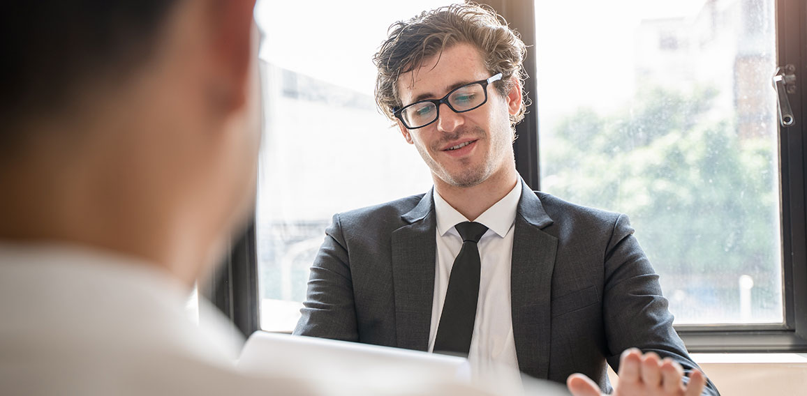 interviewer on the table asking question applicant in the office