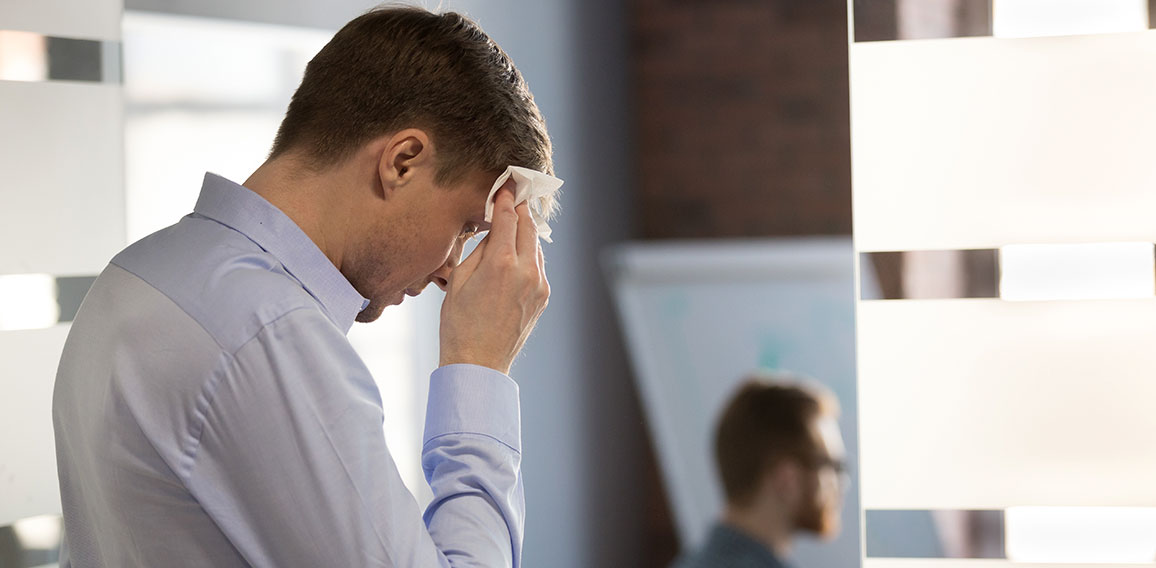 Nervous sweaty speaker preparing speech wiping wet forehead with