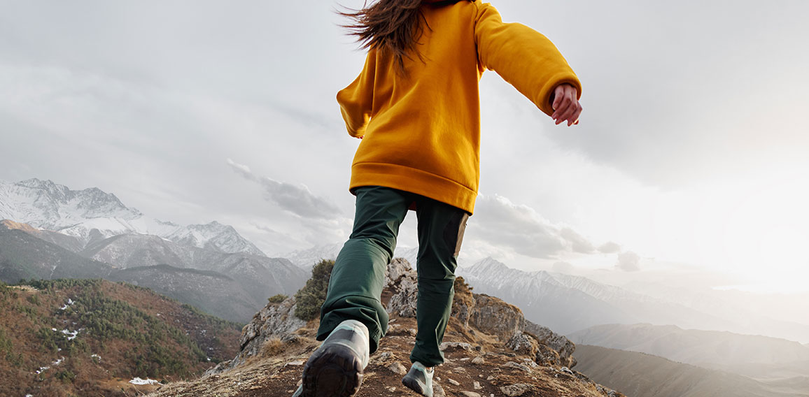 Sporty girl runs high in mountains