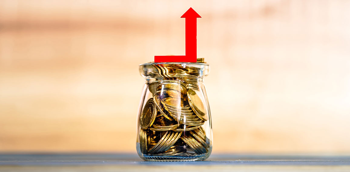 Bottle bank with gold coins inside and red arrow graph with grow