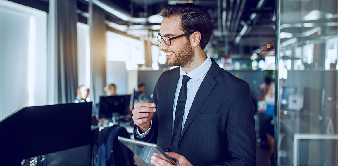 Handsome caucasian bearded smiling businessman in suit and with