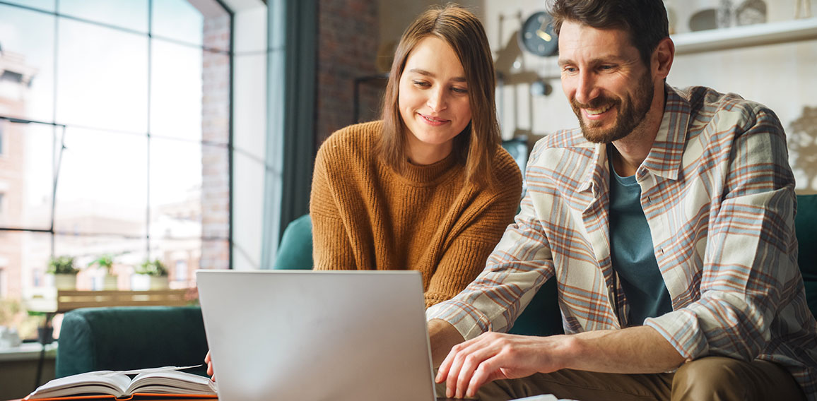 Doing Accounting at Home: Happy Couple Using Laptop Computer, Si