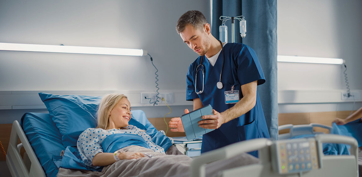 Hospital Ward: Friendly Male Nurse Talks to Beautiful Female Pat