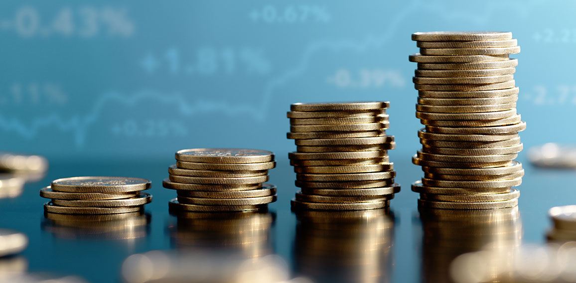 Investment and asset management yield. Stacked coins and graph.