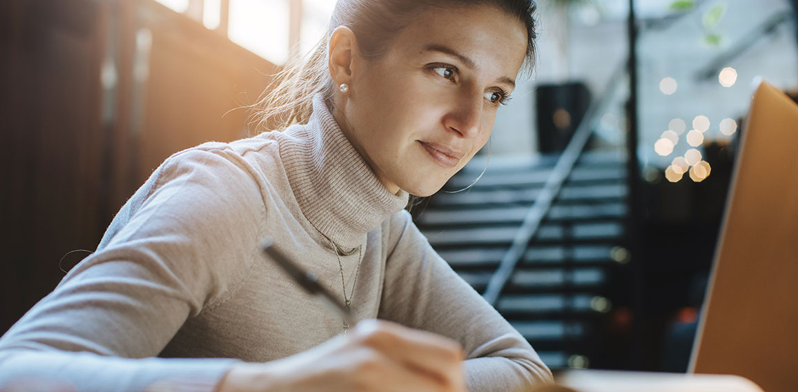 Attractive woman reading good news from business partners on lap