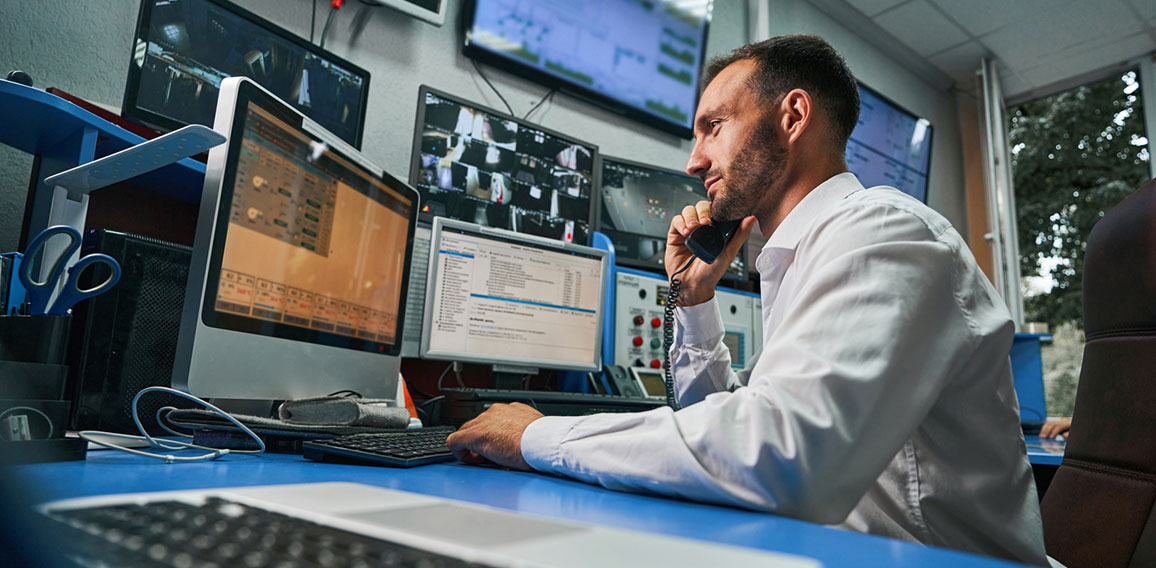 Server technician answering phone call from control room