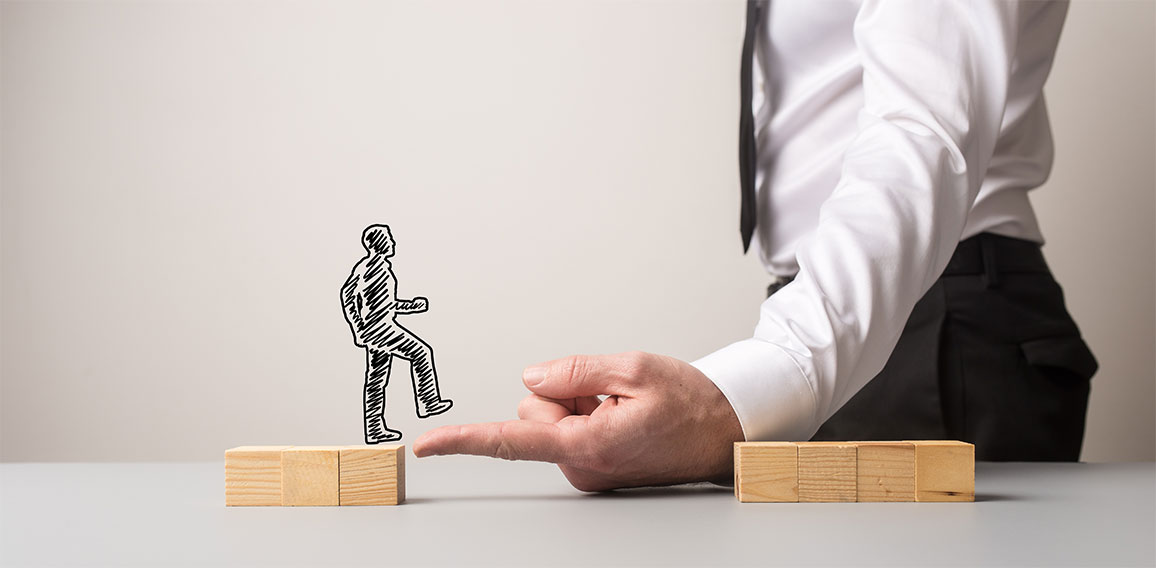 Businessman making a bridge of his finger for a silhouetted busi