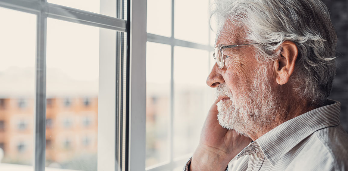 Pensive elderly mature senior man in eyeglasses looking in dista