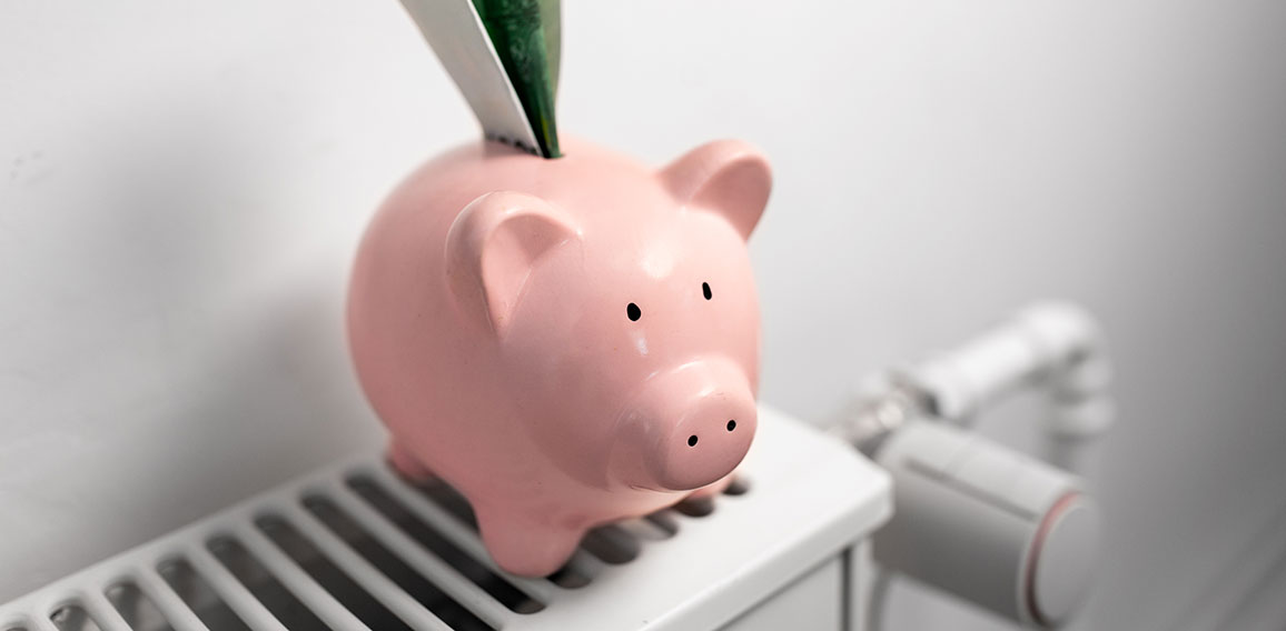 piggy bank with money on radiator at home