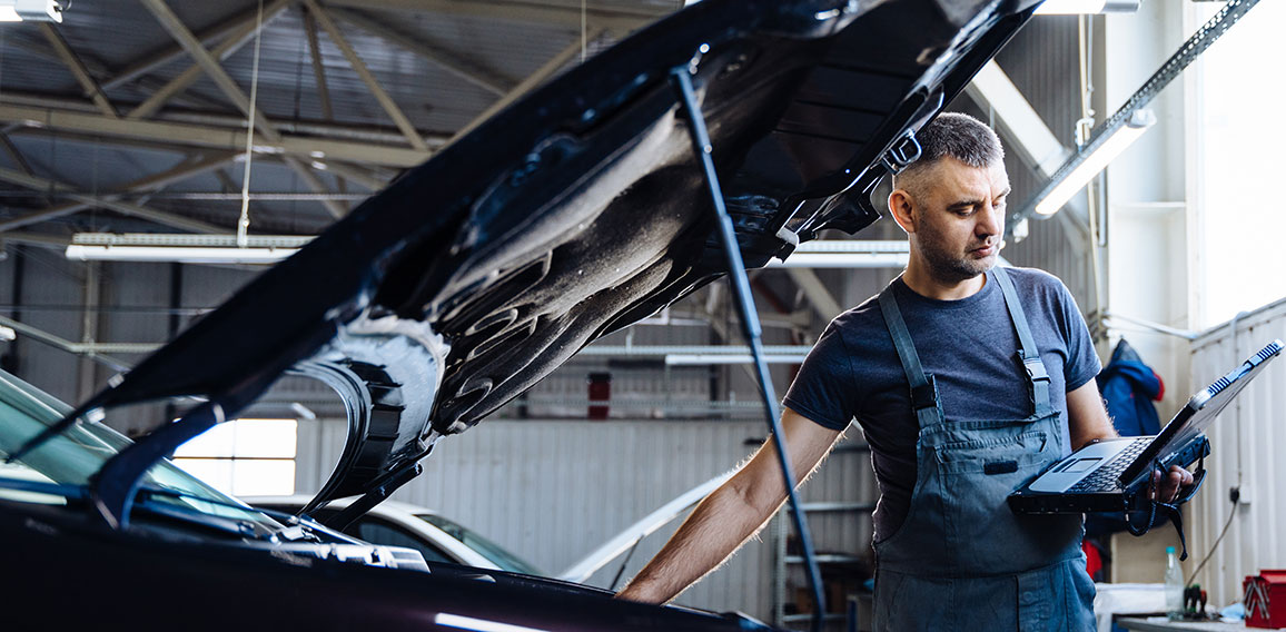 Auto service, repair, maintenance concept. Mechanic checks the car at the service station. Service maintenance of industrial to engine repair.