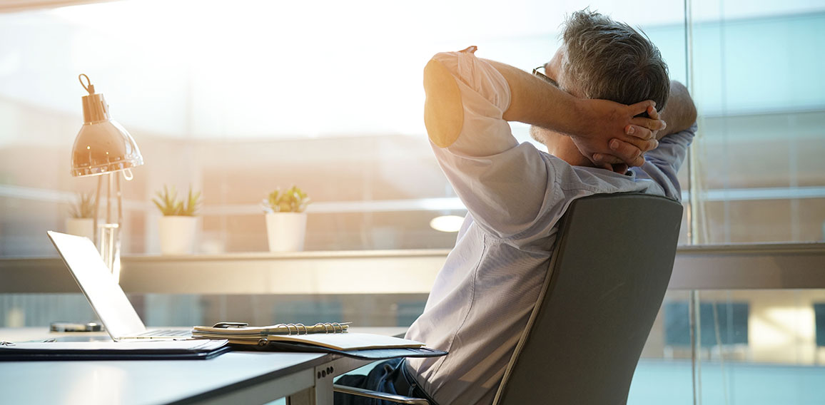 Businessman in office relaxing in chair